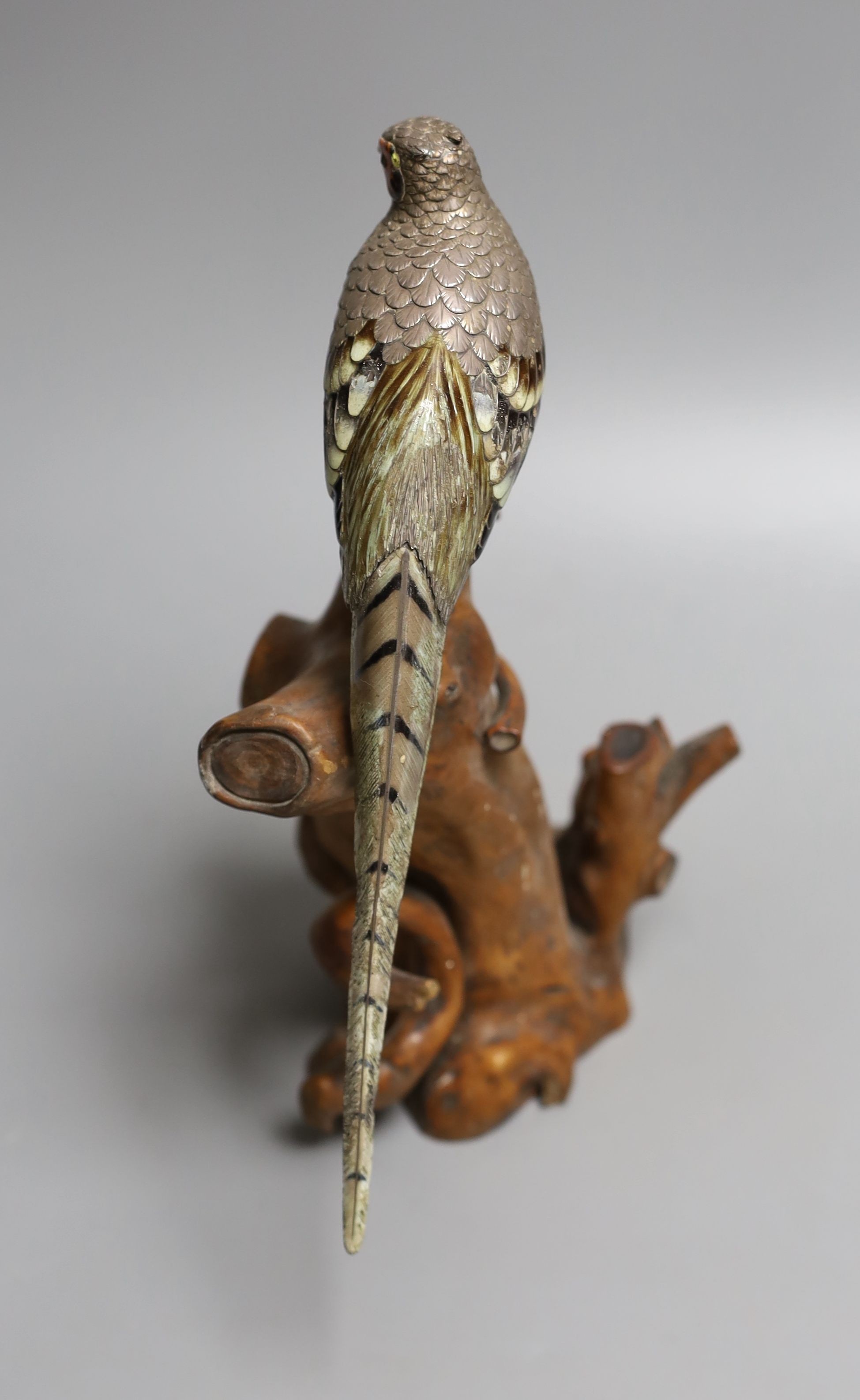 A Japanese? white metal and polychrome enamelled model of a pheasant on a root wood stand, bird 24.3cm, stand 17cm, enamel a.f., bird gross 197 grams.